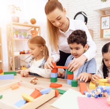 Building block towers with a teacher